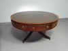 Mahogany Victorian " Heldense " Coffee table / Drum table with leather top on brass wheels. '80s