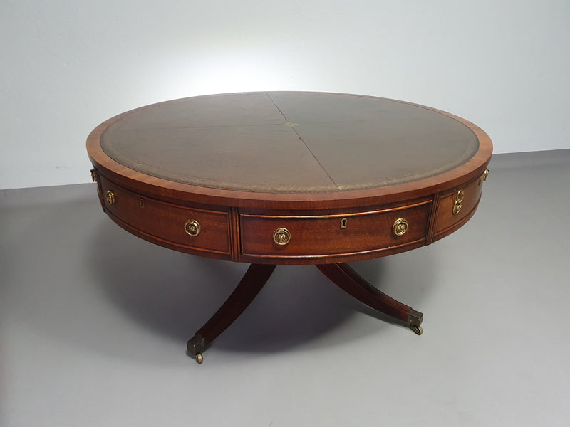 Mahogany Victorian " Heldense " Coffee table / Drum table with leather top on brass wheels. '80s