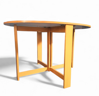 Vintage scandinavian folding dining table with side leaves. The oval top is made of white formica