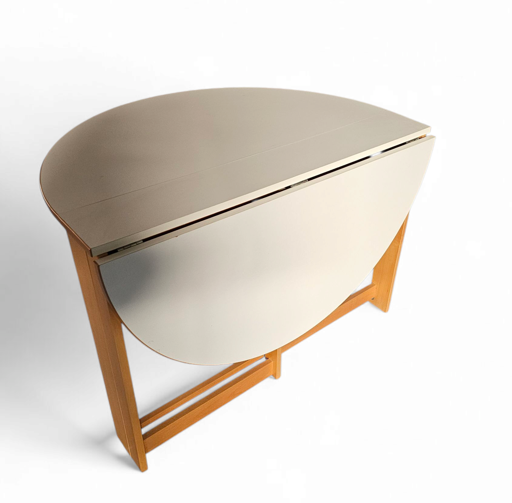 Vintage scandinavian folding dining table with side leaves. The oval top is made of white formica