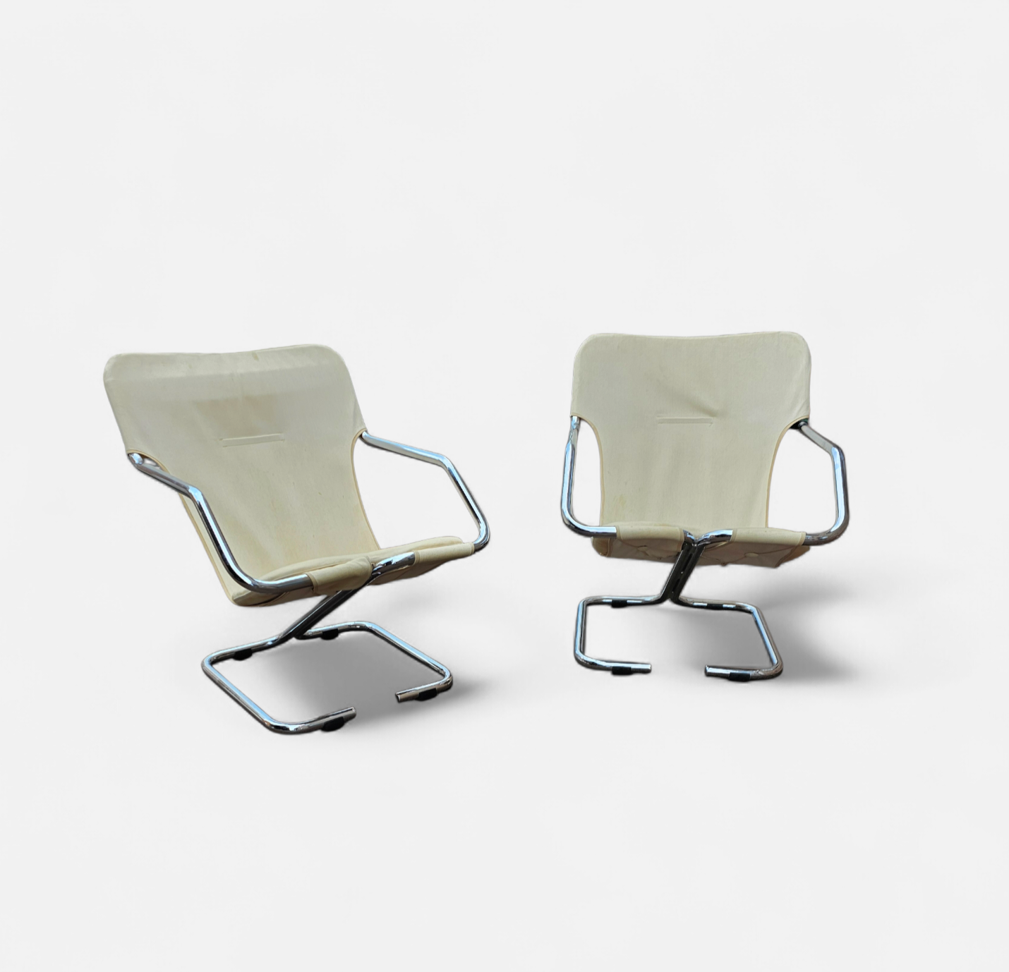 2 x Tubular chrome cantilever chair with a cream canvas sling