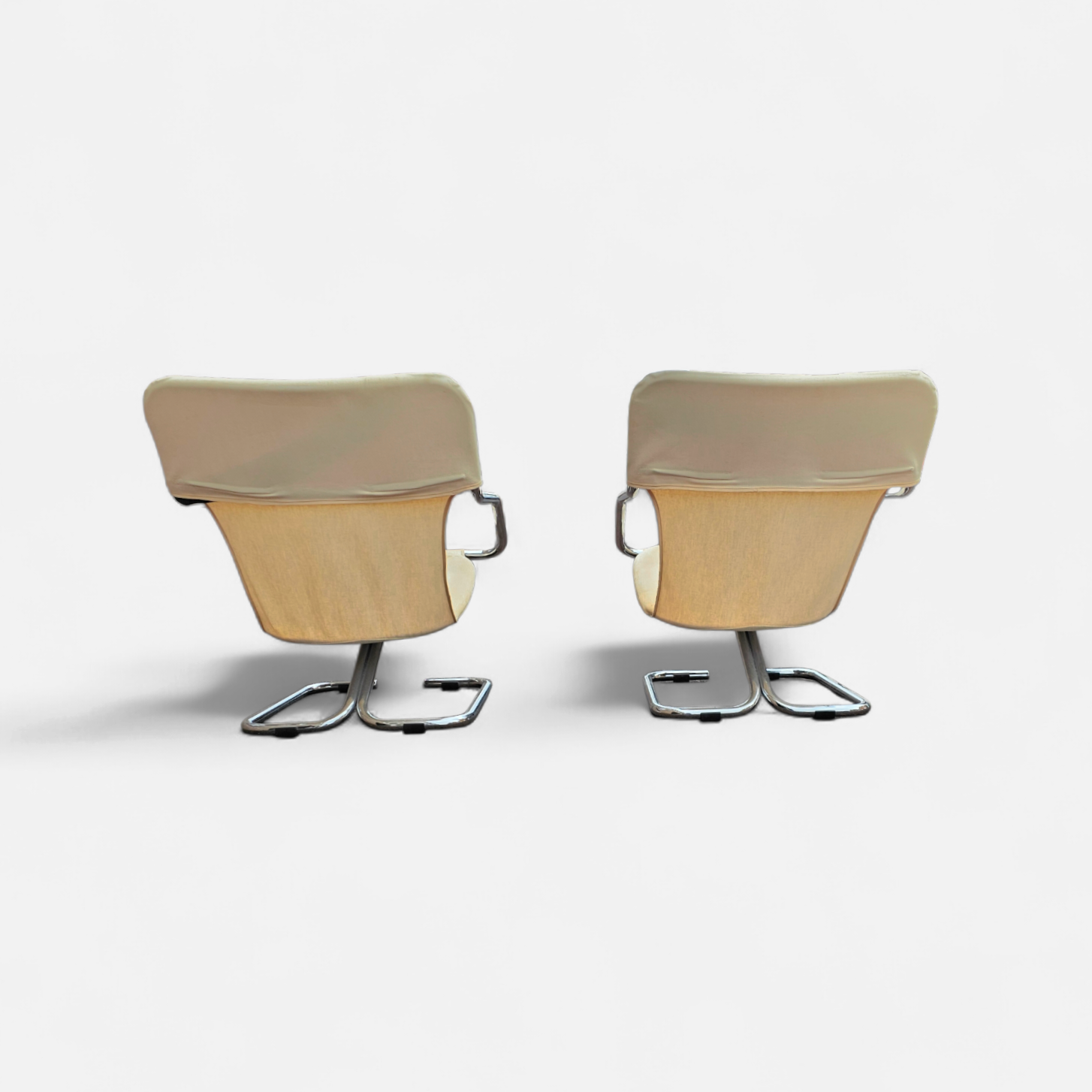 2 x Tubular chrome cantilever chair with a cream canvas sling