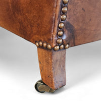 Beautiful and stately old English sheep leather club chair with armrests
