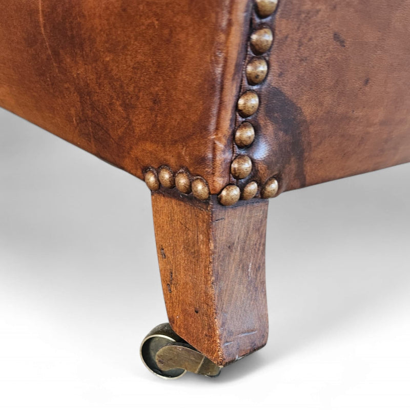 Beautiful and stately old English sheep leather club chair with armrests