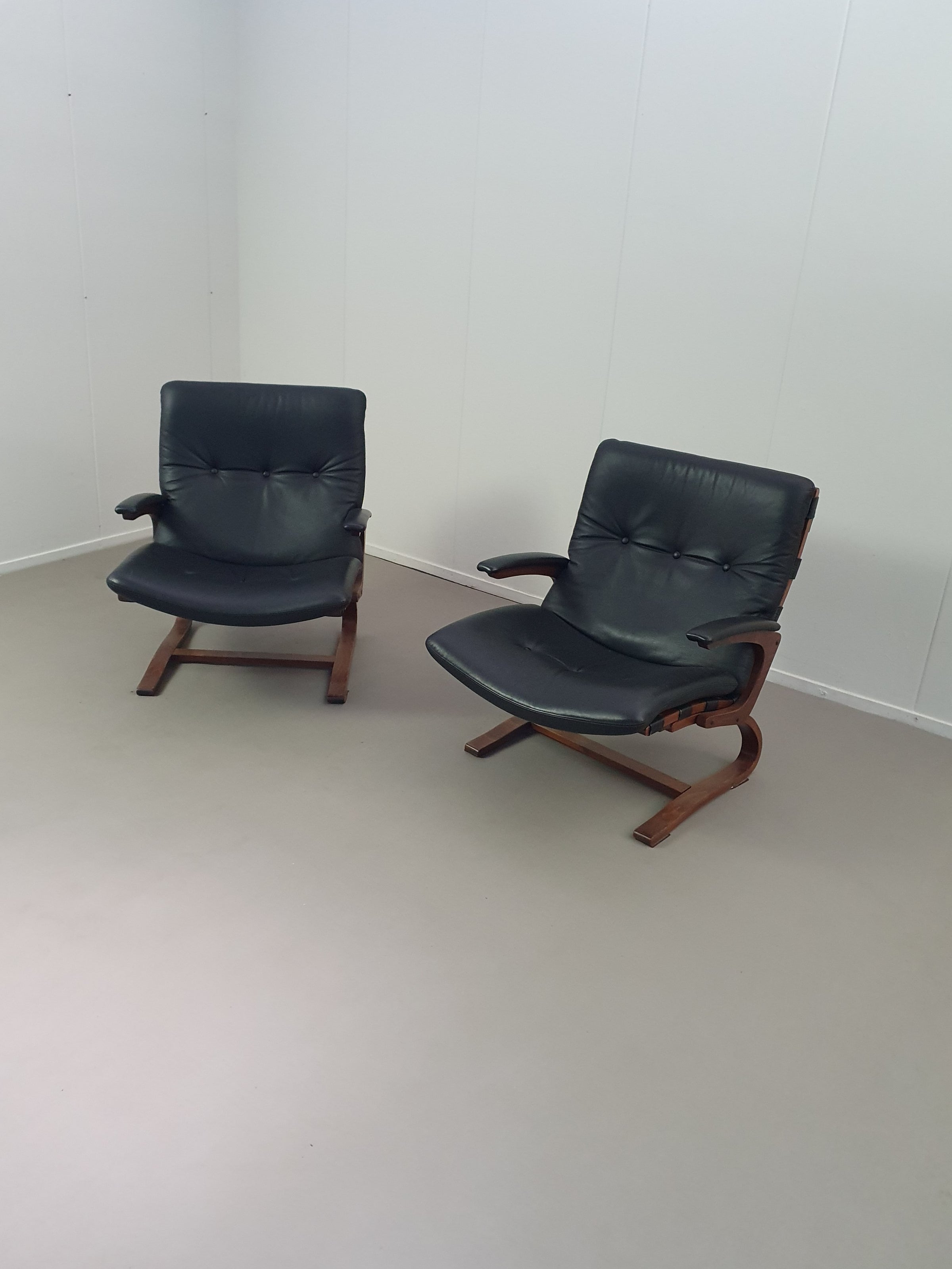 2 x Scandinavian black leather lounge chairs