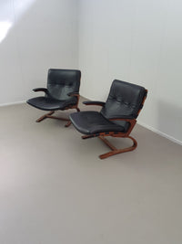2 x Scandinavian black leather lounge chairs