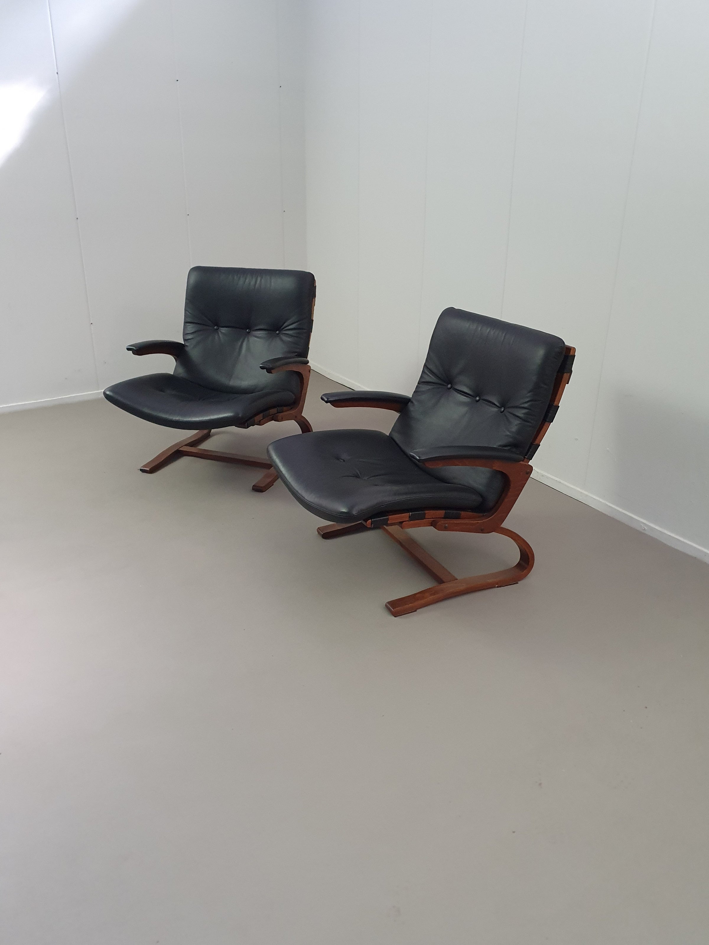 2 x Scandinavian black leather lounge chairs