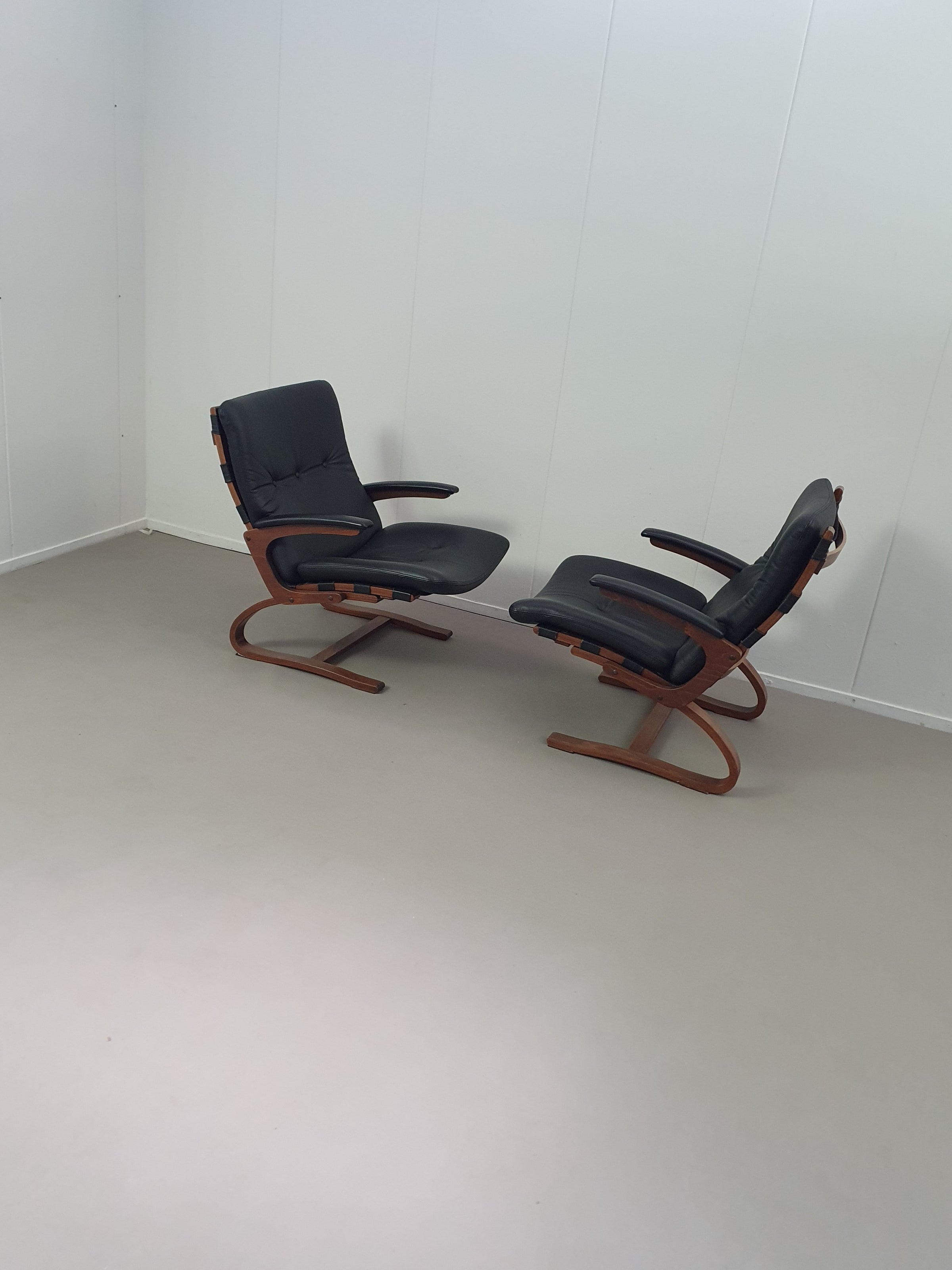 2 x Scandinavian black leather lounge chairs