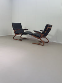 2 x Scandinavian black leather lounge chairs
