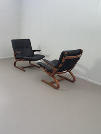 2 x Scandinavian black leather lounge chairs